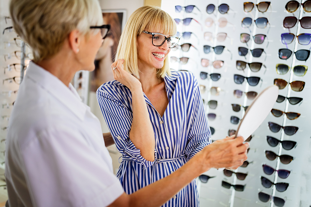 Woman trying on glasses in store